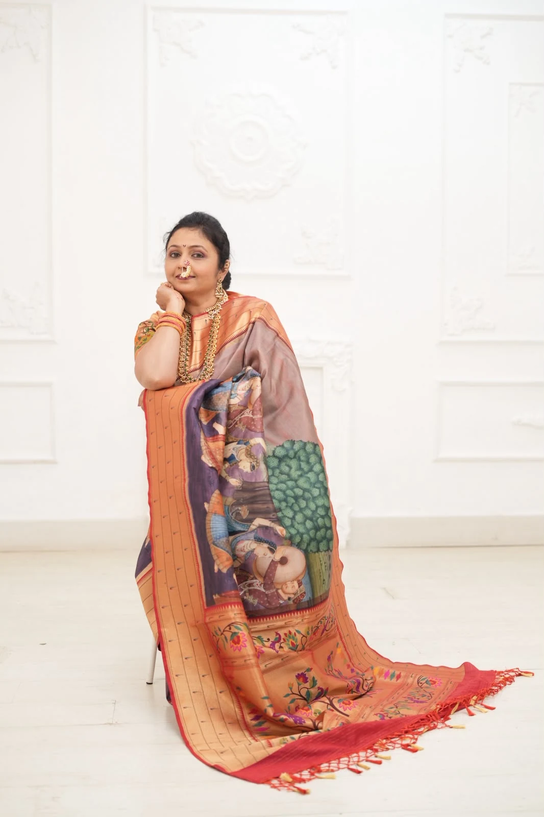 Shweta Bobde, founder of Kulswamini Paithani, displaying the full pictorial pallu of a handwoven Paithani